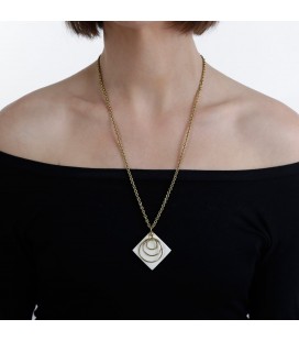 Three brass rings on a white piece necklace