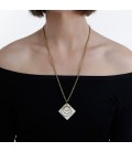 Three brass rings on a white piece necklace